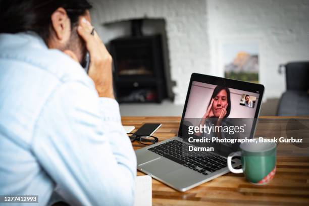 a woman and a man video teleconferencing, the woman is smiling - coronavirus dating stock pictures, royalty-free photos & images