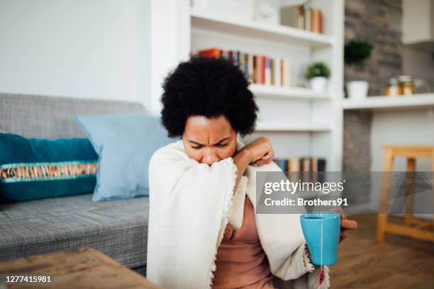 sick african american woman staying at home - woman cough stock pictures, royalty-free photos & images