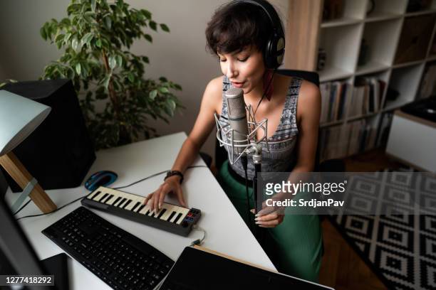 female music producer, keyboard player and singer making music in the music studio - song writer stock pictures, royalty-free photos & images
