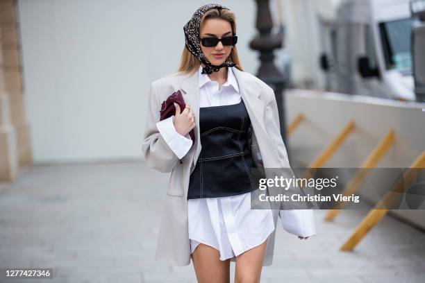 Guest is seen wearing corset, head scarf, blazer, white button shirt worn as a dress, black boots outside Victoria/Tomas during Paris Fashion Week -...
