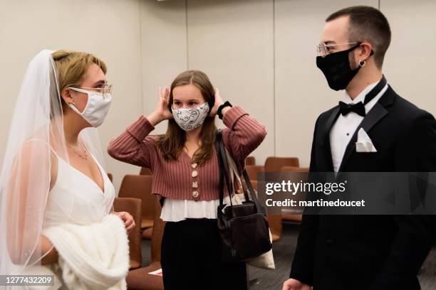 newlyweds putting back protective face mask after ceremonie. - covid wedding stock pictures, royalty-free photos & images