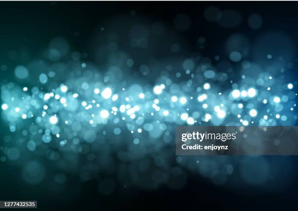 sparkling blue glitter vector illustration - light trail black background stock illustrations