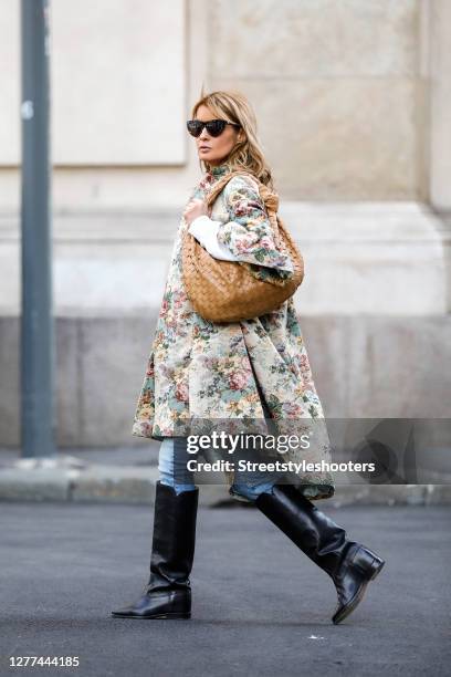 Influencer Gitta Banko, wearing a brokat coat with floral print by Celine, a light blue jeans by Jeans AG, black knee high boots by Isabel Marant, a...