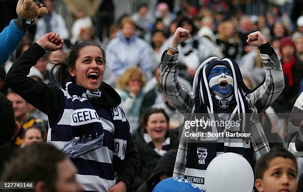 Geelong Cats supporters celebrate as they watch the 2011 AFL Grand Final match between the Collingwood Magpies and the Geelong Cats at Federation...