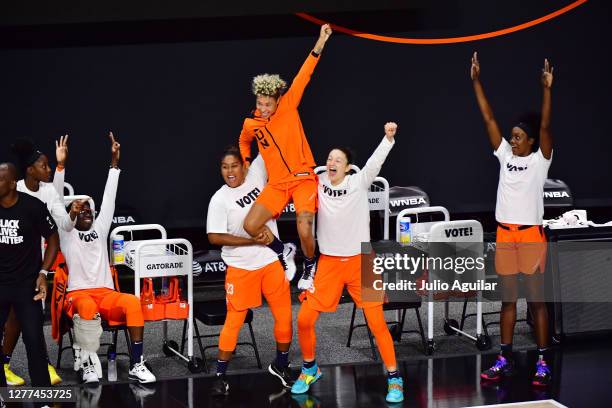 Essence Carson, Kaleena Mosqueda-Lewis, Natisha Hiedeman, Theresa Plaisance, and Kaila Charles of the Connecticut Sun react to a three pointer by...