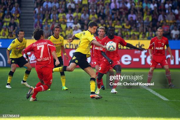 Robert Lewandowski of Dortmund scores the first goal against Hajime Hosogai and Gibril Sankoh during the Bundesliga match between Borussia Dortmund...