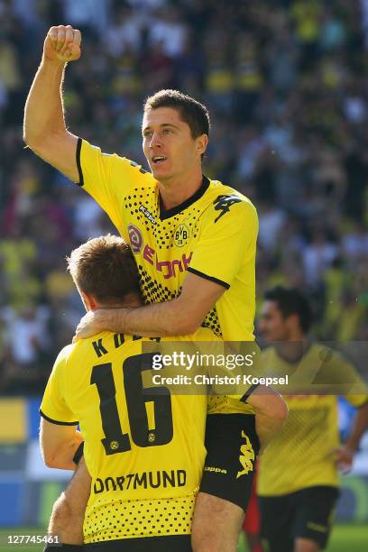 Robert Lewandowski of Dortmund celebrates the first goal with Jakub Blaszczykowski during the Bundesliga match between Borussia Dortmund and FC...