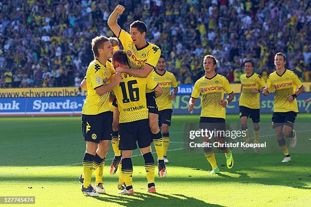 Robert Lewandowski celebrates the first goal with Lukasz Piszczek , Jakub Blaszczykowski and team mates during the Bundesliga match between Borussia...