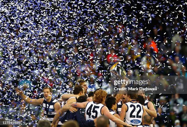Geelong players celebrate on the dais after winning the 2011 AFL Grand Final match between the Collingwood Magpies and the Geelong Cats at Melbourne...