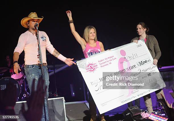 Jason Aldean, Jess Aldean and Guest display chech raising over 300 thousand dollars to be donated to the local chapter of the Susan G. Koman...