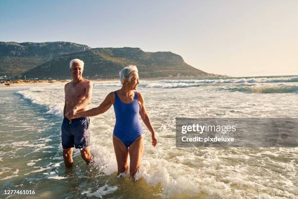 splashing around paradise - older woman bathing suit stock pictures, royalty-free photos & images