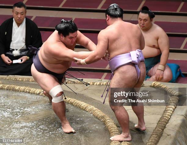 Myogiryu pushes Kotoeko out of the ring to win on day twelve of the Grand Sumo Autumn Tournament at Ryogoku Kokugikan on September 24, 2020 in Tokyo,...