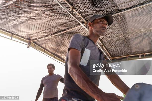a captain is ruling a small boat - sri lankan ethnicity stock pictures, royalty-free photos & images