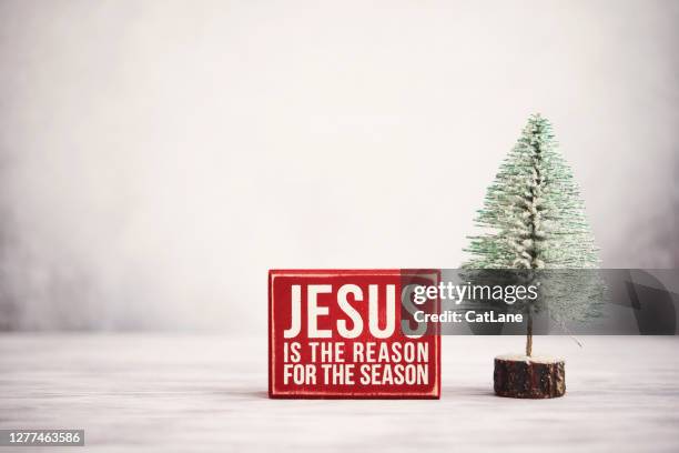 christmas background with christmas tree and jesus is the reason sign - jesus christ christmas stock pictures, royalty-free photos & images