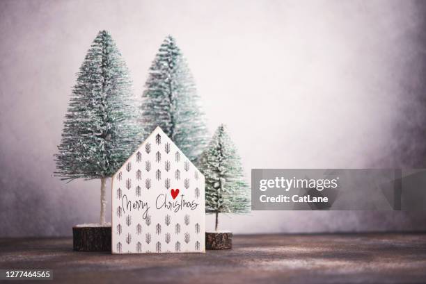 christmas background with wooden house and christmas trees - christmas sayings stock pictures, royalty-free photos & images