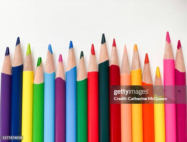 brightly colored art pencils in a row - colored pencil stockfoto's en -beelden