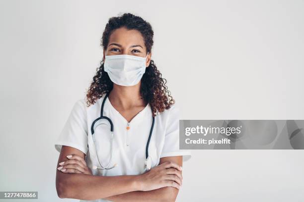 african ethnicity female doctor with a face mask - female doctor with mask stock pictures, royalty-free photos & images