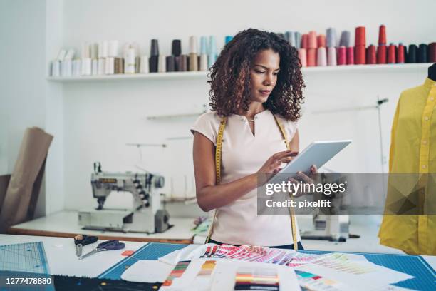 designer with a digital tablet - clothing-design-studio stock pictures, royalty-free photos & images