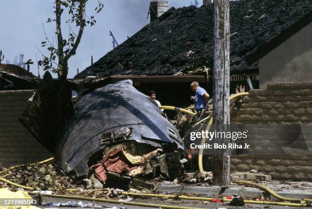Los Angeles County rescue personel work within the debris field after mid-air collision with Aeromexico Flight 498 and Piper Archer aircraft, August...