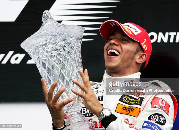British McLaren Formula One driver Lewis Hamilton celebrates winning his first Grand Prix on the winners podium of the 2007 Canadian Grand Prix held...