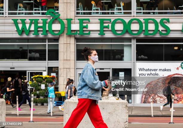 Person wears a face mask outside Whole Foods Market in Union Square as the city continues Phase 4 of re-opening following restrictions imposed to...