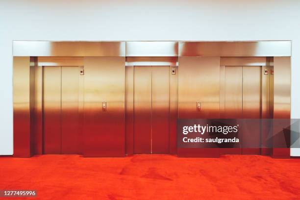 a row of three lifts - hairline polished metal bildbanksfoton och bilder