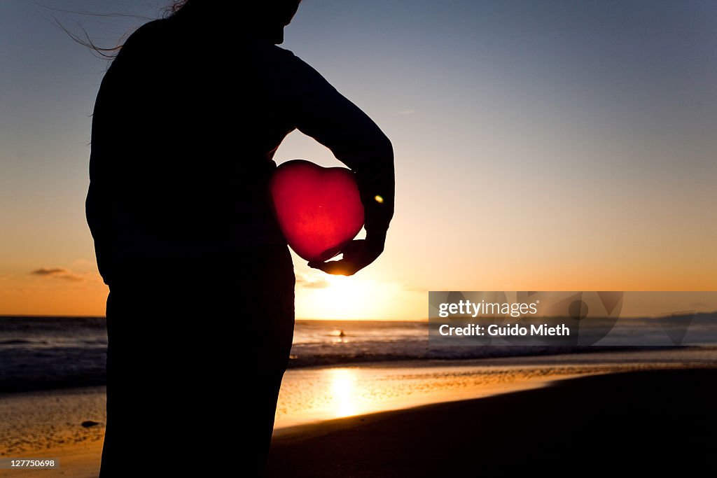 Woman holding balloon heart