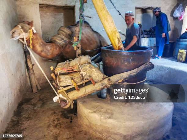 afghan man working on the old mill - afghan old man stock pictures, royalty-free photos & images