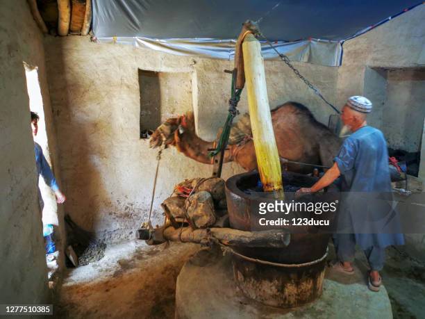 afghan man working on the old mill - afghan old man stock pictures, royalty-free photos & images