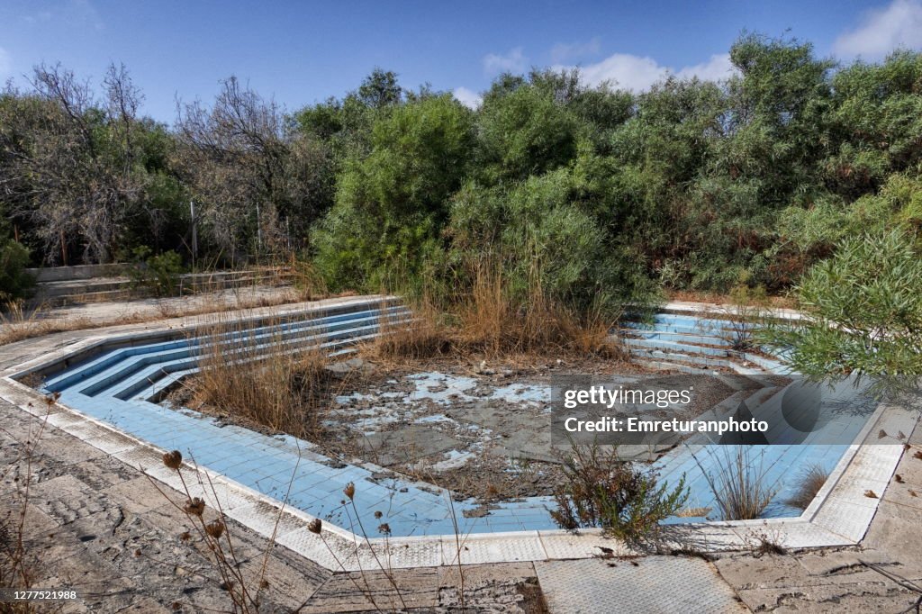 Abandoned children's pool at Zeytineli beach on a sunny autumn day.