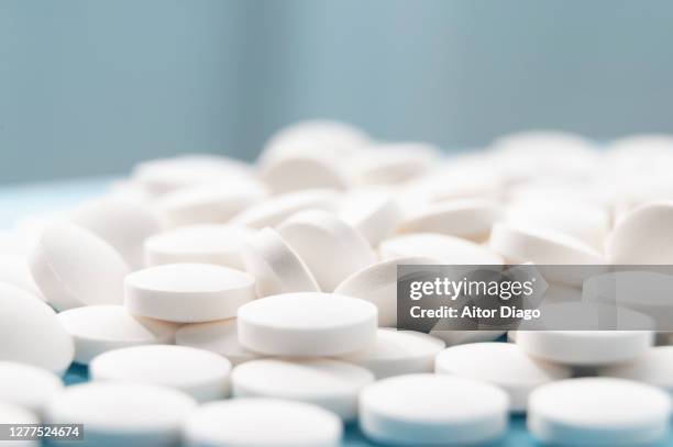 plenty vitamins pills on a table. - ibuprofen stock-fotos und bilder