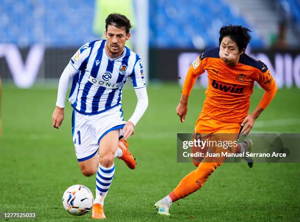 David Silva of Real Sociedad duels for the ball with Kang-in Lee of Valencia CF during the La Liga Santander match between Real Sociedad and Valencia...