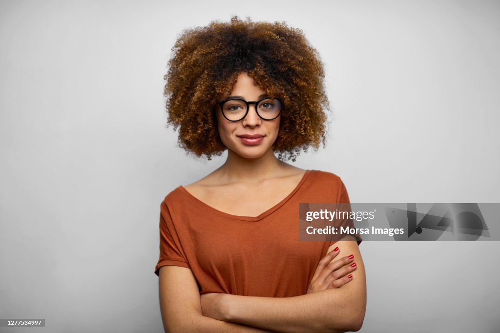 Smiling Young Female Afro Owner Against White Background