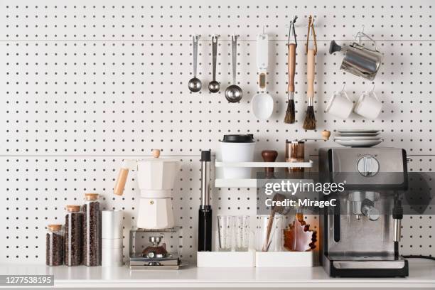 espresso coffee maker and accessories on pegboard - kökstillbehör bildbanksfoton och bilder
