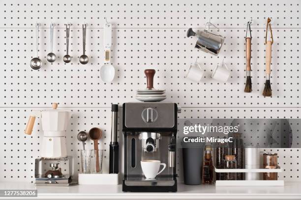 espresso coffee maker and accessories on pegboard - máquina de café imagens e fotografias de stock
