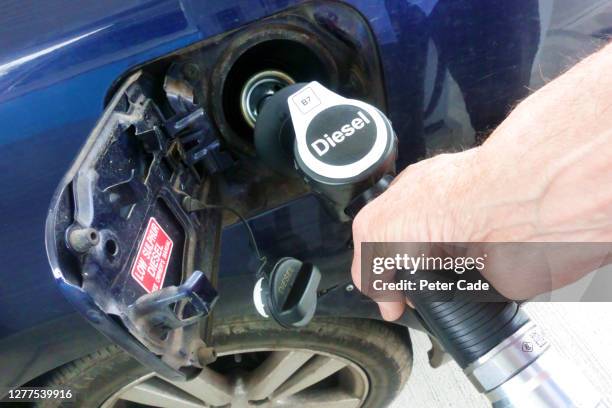 putting diesel into car - diesel fuel stock pictures, royalty-free photos & images