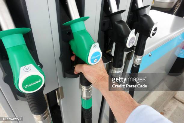 picking up unleaded fuel pump - hydrocarbon stock-fotos und bilder