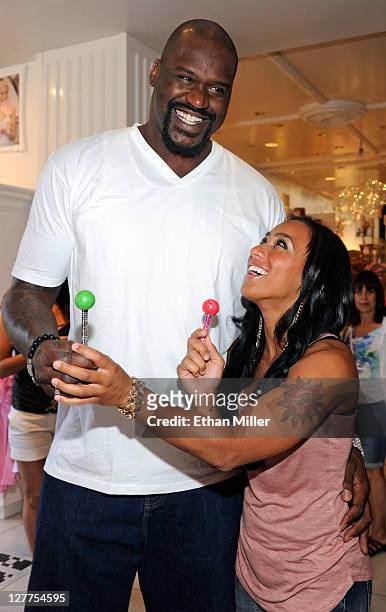 Former NBA player Shaquille O'Neal and television personality Nicole "Hoopz" Alexander, joke around with couture lollipops at the Sugar Factory...