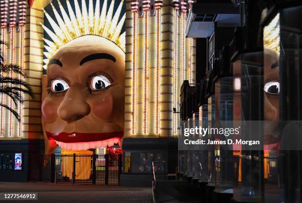 The face at the entrance to Luna Park with its teeth lit red on September 30, 2020 in Sydney, Australia. Iconic entertainment sites around Australia...