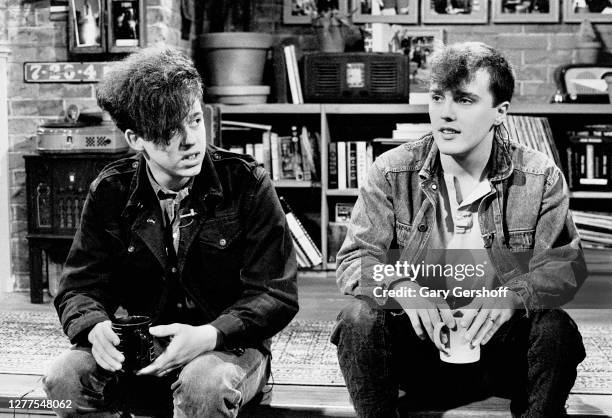 View of English Alternative and Pop musicians Roland Orzabal and Curt Smith, both of the group Tears For Fears as they sit on a low stage during an...