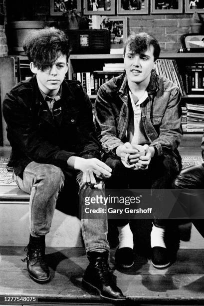 View of English Alternative and Pop musicians Roland Orzabal and Curt Smith, both of the group Tears For Fears as they sit on a low stage during an...