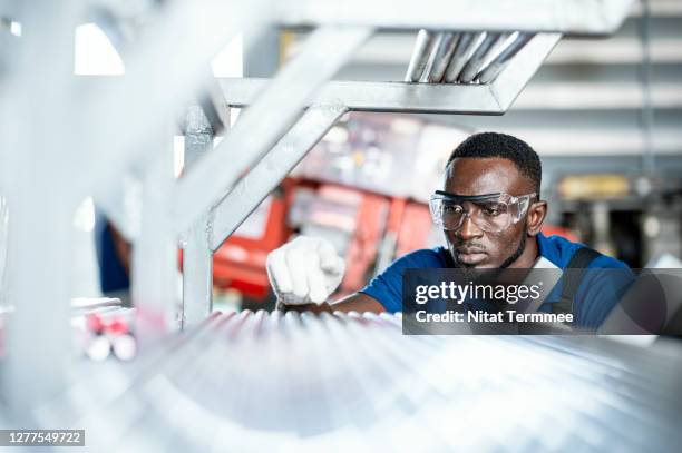 quality control engineer inspecting steel pipe material for production on shelf rack at factory warehouse. quality control assurance. - factory workers stockfoto's en -beelden