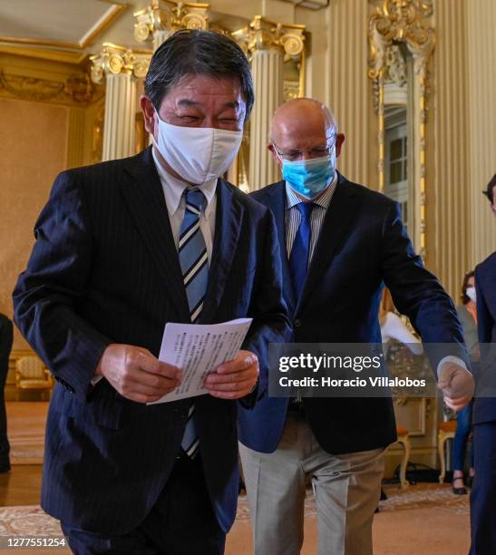 Japanese Foreign Minister Toshimitsu Motegi and the Portuguese Minister of State and Foreign Affairs Augusto Santos Silva wear protective masks as...