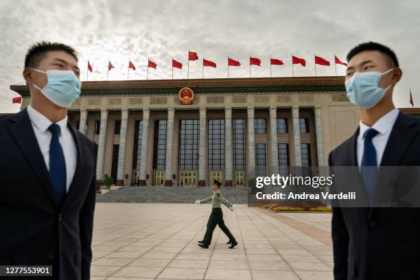 Security guards stand and soldiers march in front of the Great Hall of the People before the National Day Reception on September 30, 2020 in Beijing,...