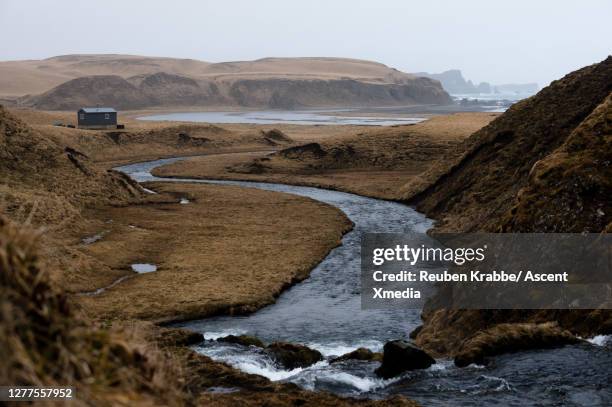 a river winds through the tundra towards the ocean - houses of alaska stock pictures, royalty-free photos & images