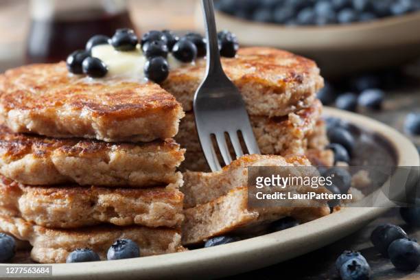 whole wheat, buttermilk blueberry pancakes with fresh blueberries and maple syrup - whole wheat stock pictures, royalty-free photos & images