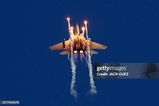 Israel's F-15 Eagle fighter plane performs during the graduation ceremony of Israeli Air Force pilots at the Hatzerim base in the Negev desert, near...