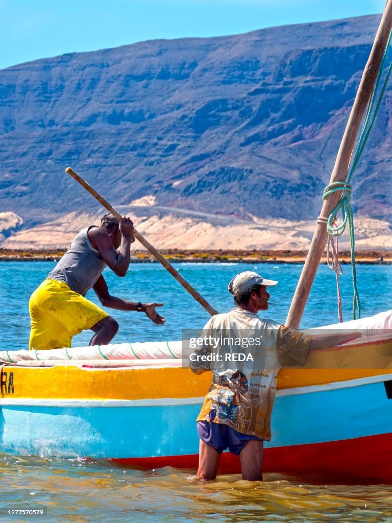 Fishermen getting ready to go fishing with traditional fishing boats near Baia das Gatas. Island Sao Vicente. Cape Verde an archipelago in the equatorial. central Atlantic in Africa.