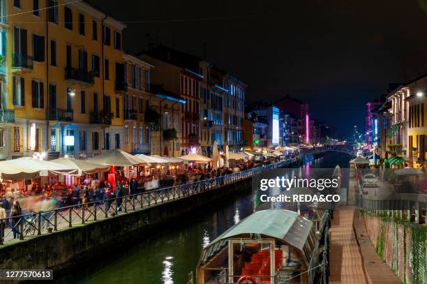 People have fun in the evening bars at Navigli District. Milan. Lombardy. Italy. Europe.