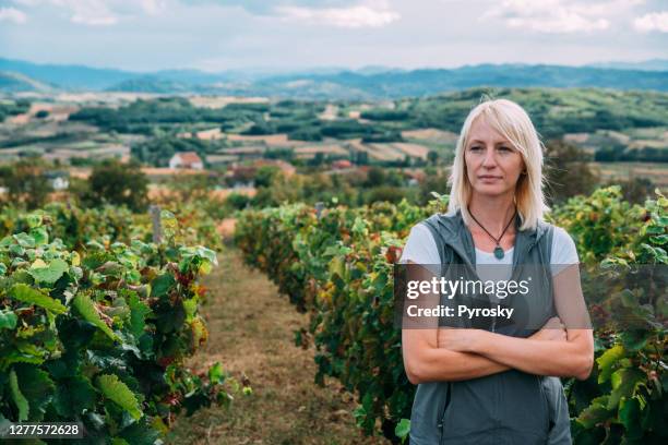 winery owner posing in her vineyard - moody sky stock pictures, royalty-free photos & images